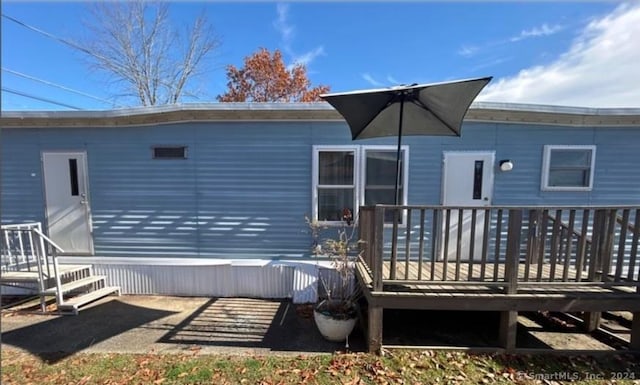 back of house featuring a wooden deck