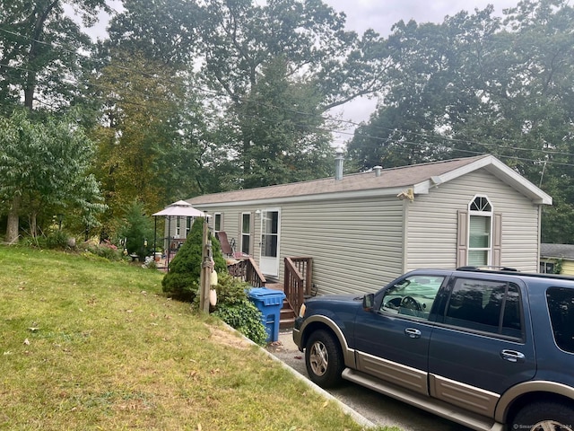 view of side of property with a lawn