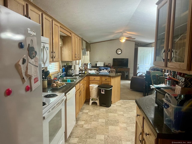 kitchen featuring a ceiling fan, a sink, a peninsula, open floor plan, and white appliances