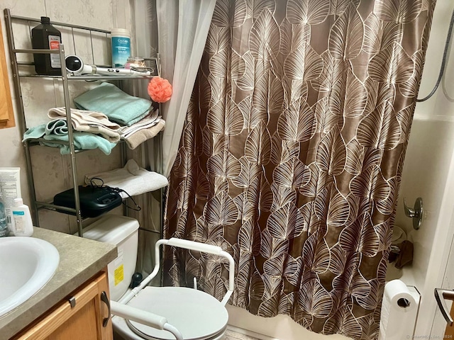 bathroom with vanity, shower / bath combo with shower curtain, and toilet