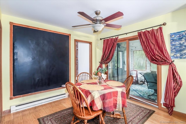 dining area with ceiling fan, baseboard heating, and light wood-type flooring