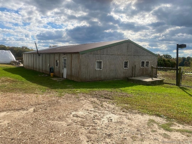 view of side of home with a lawn