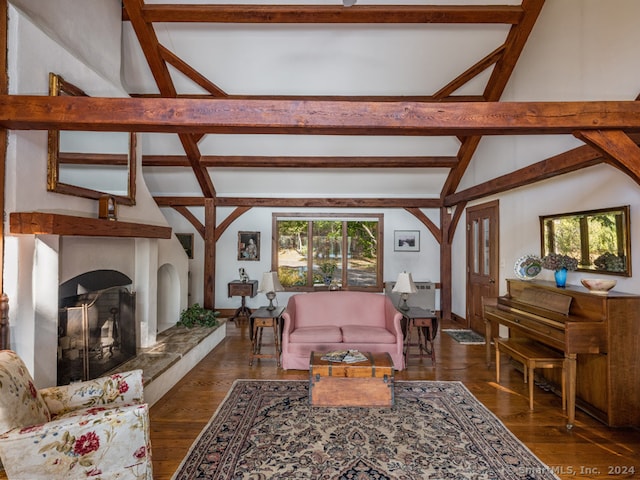 living room with beamed ceiling, dark hardwood / wood-style flooring, and high vaulted ceiling