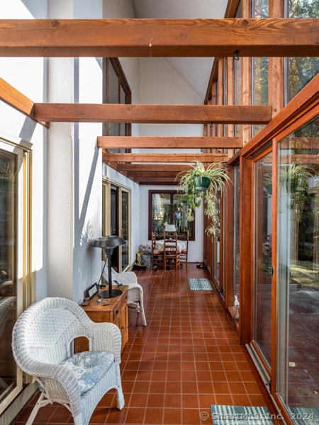 sunroom with lofted ceiling with beams