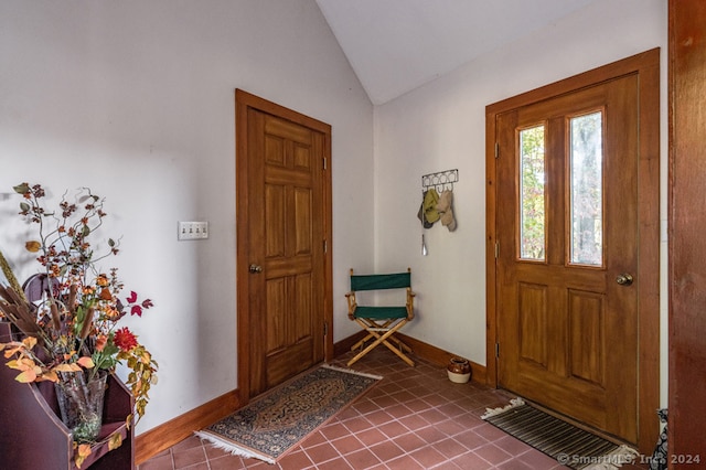 foyer with lofted ceiling and tile patterned floors