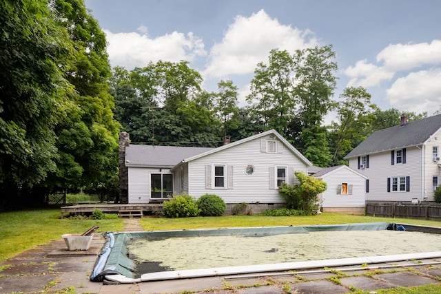 back of property featuring a deck and a yard