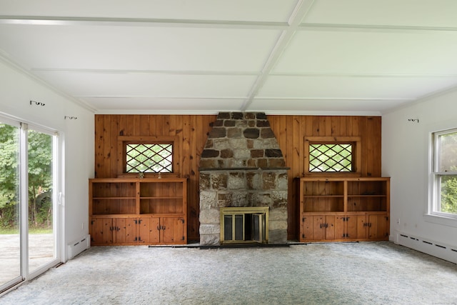 unfurnished living room with ornamental molding, carpet, a baseboard heating unit, coffered ceiling, and a fireplace