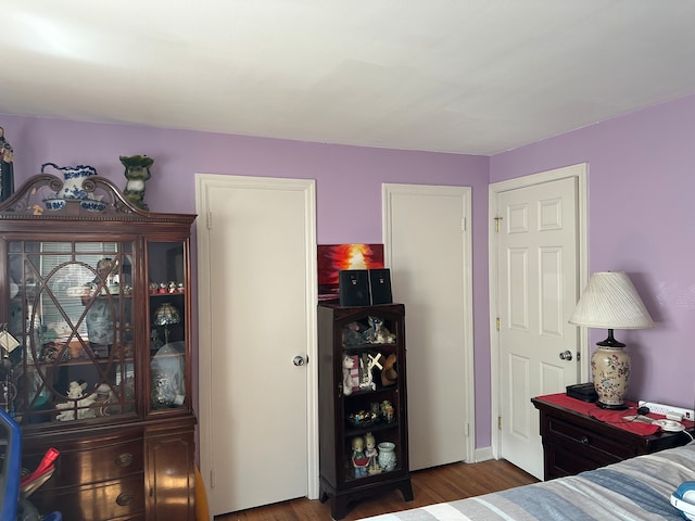 bedroom with dark hardwood / wood-style flooring