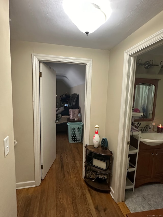 corridor featuring hardwood / wood-style floors and sink