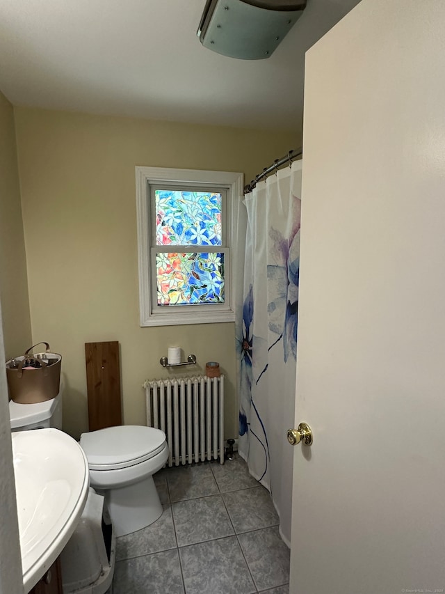 bathroom featuring radiator, vanity, tile patterned floors, and toilet