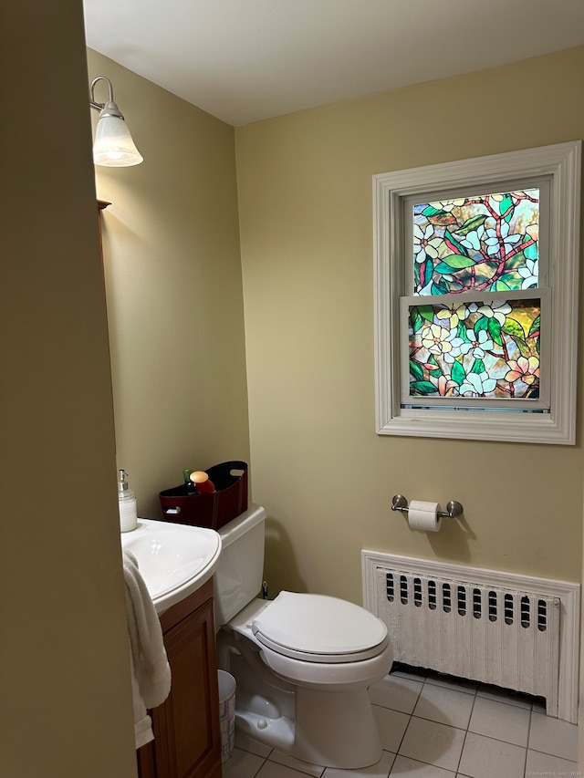 bathroom featuring radiator, tile patterned flooring, vanity, and toilet