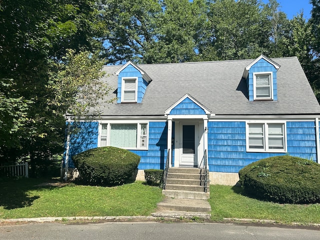 cape cod house featuring a front lawn