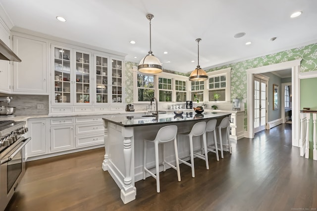147 Old Church Rd, Greenwich, CT 06830 - kitchen featuring stainless steel gas range, wallpapered walls, a sink, crown molding, and glass insert cabinets