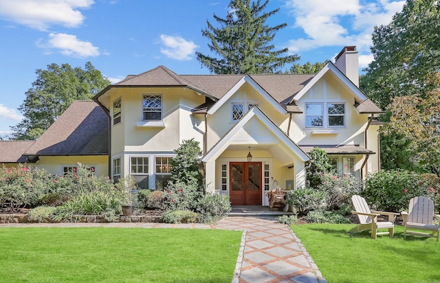 147 Old Church Rd, Greenwich, CT 06830 - tudor house with french doors, stucco siding, a chimney, and a front yard