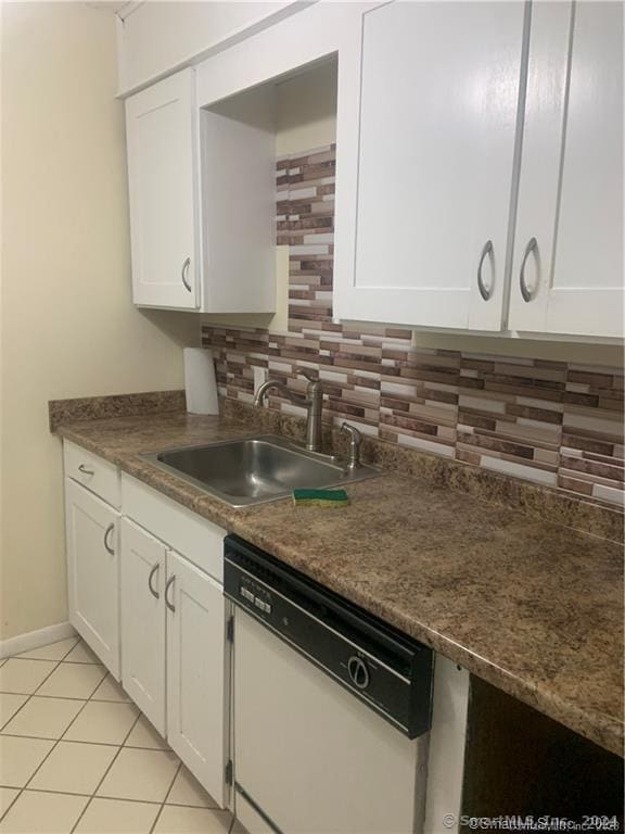 kitchen featuring white cabinets, white dishwasher, and tasteful backsplash