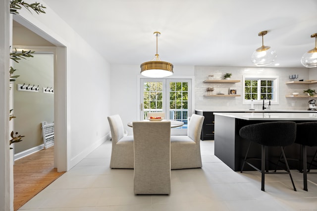 dining room featuring sink and light hardwood / wood-style flooring