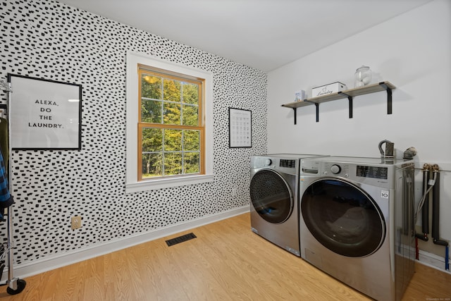 laundry area featuring light hardwood / wood-style floors and separate washer and dryer