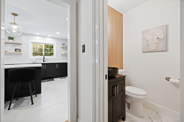 bathroom featuring vanity and toilet