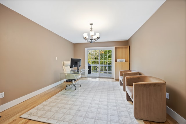 office space with a chandelier and light hardwood / wood-style floors