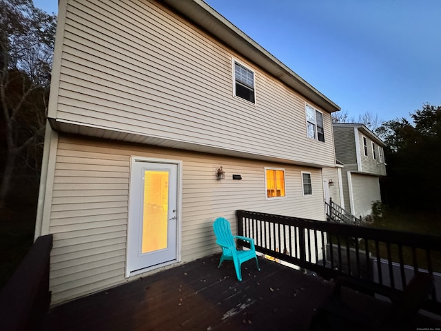 rear view of house featuring a wooden deck