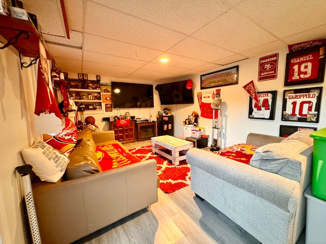 living room with hardwood / wood-style flooring and a drop ceiling