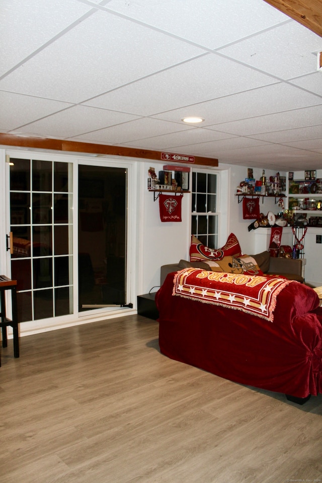 living room featuring hardwood / wood-style floors and a paneled ceiling