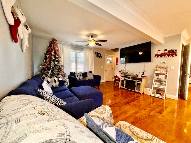 living room with ceiling fan, beam ceiling, and wood-type flooring