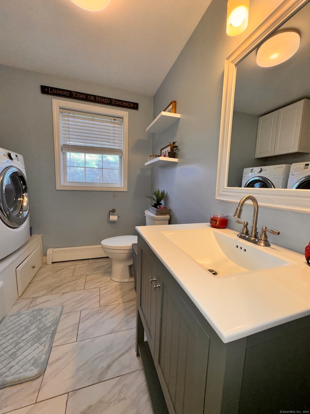 bathroom featuring washer and dryer, toilet, baseboard heating, and vanity