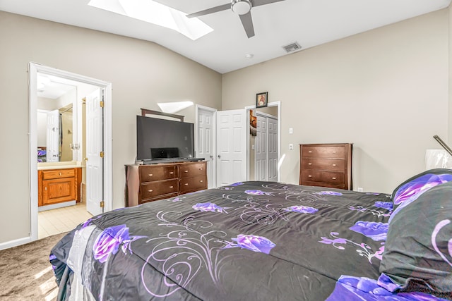 carpeted bedroom with connected bathroom, vaulted ceiling, and ceiling fan