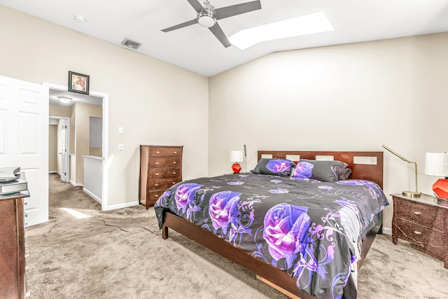 bedroom featuring ceiling fan, light colored carpet, and vaulted ceiling