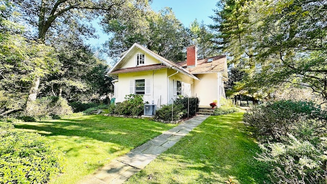 exterior space featuring a yard and central air condition unit