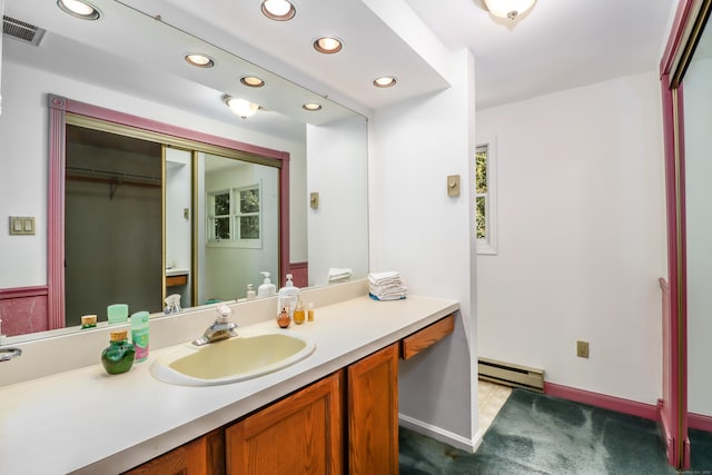 bathroom with vanity and baseboard heating