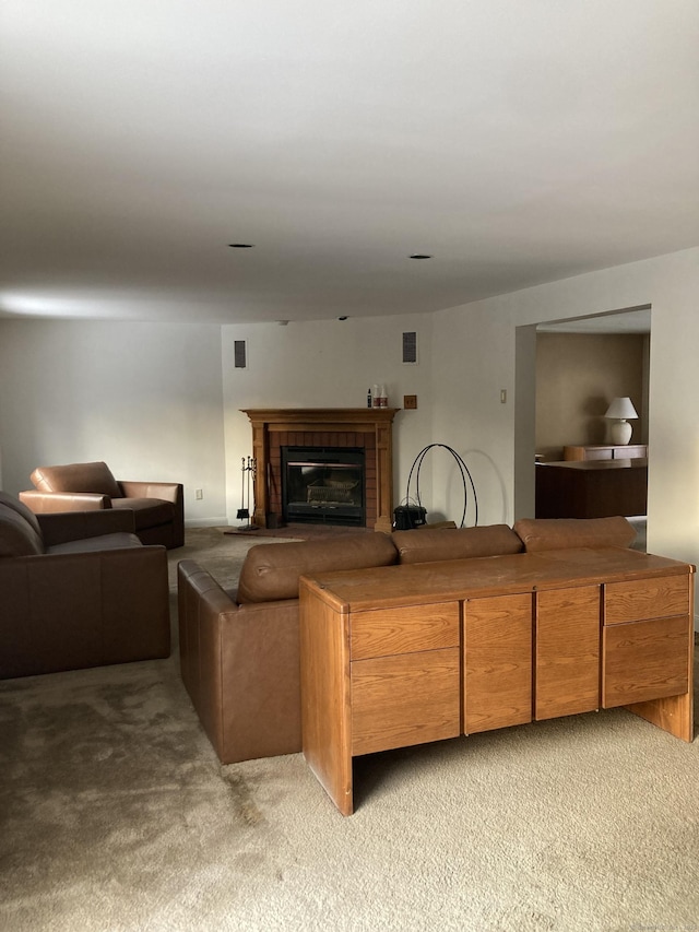 carpeted living room featuring a brick fireplace