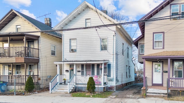 view of front of house featuring a balcony and a porch