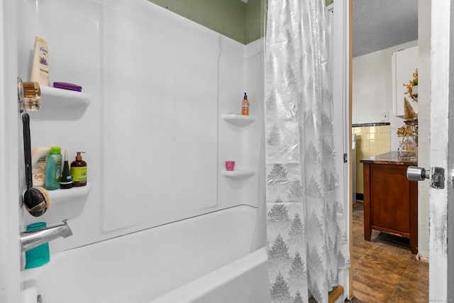 bathroom with shower / bath combo and a textured ceiling