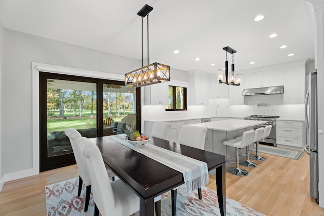 dining room featuring sink and light wood-type flooring