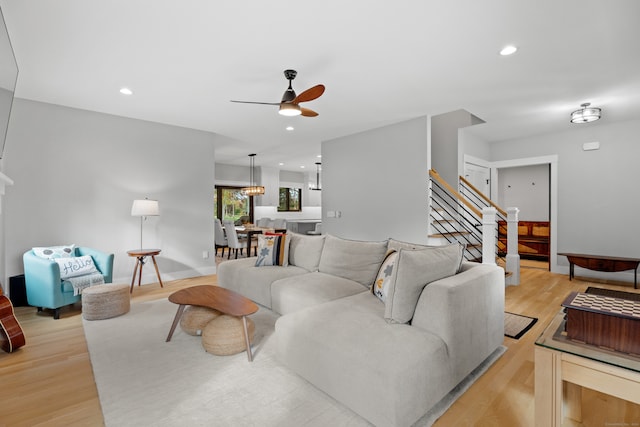 living room with ceiling fan and light hardwood / wood-style floors