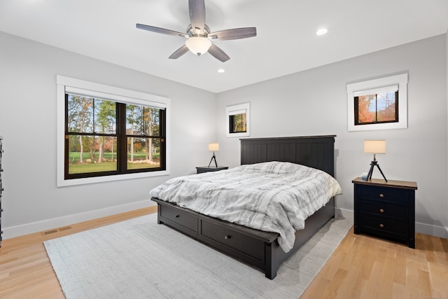 bedroom with light hardwood / wood-style floors and ceiling fan