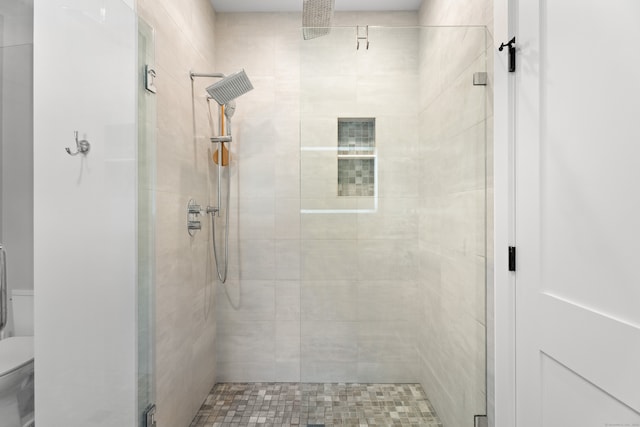 bathroom featuring toilet and walk in shower