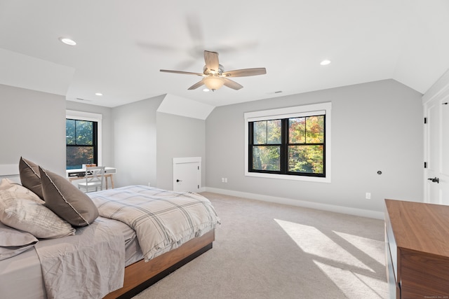 carpeted bedroom with vaulted ceiling and ceiling fan