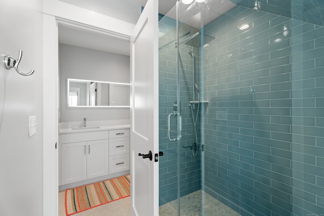 bathroom featuring vanity and a shower with shower door