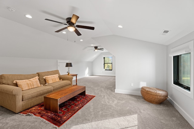 living room featuring light carpet, ceiling fan, and vaulted ceiling