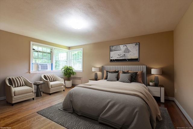 161 Dale Rd, Wethersfield, CT 06109 - bedroom featuring radiator heating unit, cooling unit, and wood finished floors