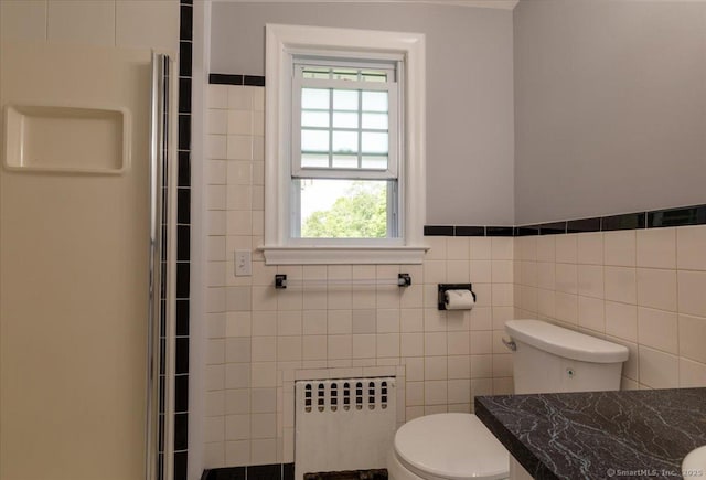 161 Dale Rd, Wethersfield, CT 06109 - full bathroom featuring radiator, a shower with shower door, tile walls, and wainscoting