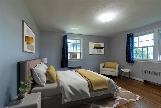 161 Dale Rd, Wethersfield, CT 06109 - bedroom featuring radiator heating unit, wood finished floors, and cooling unit