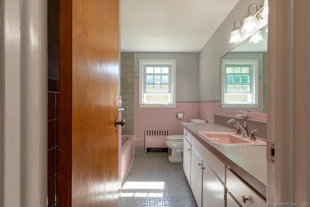 161 Dale Rd, Wethersfield, CT 06109 - bathroom with radiator heating unit, plenty of natural light, tile walls, vanity, and tile patterned floors