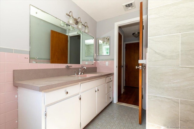 161 Dale Rd, Wethersfield, CT 06109 - bathroom with tile walls, vanity, and tile patterned flooring