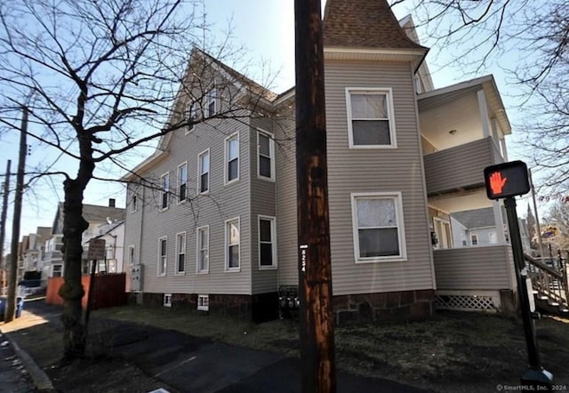 rear view of property featuring a balcony