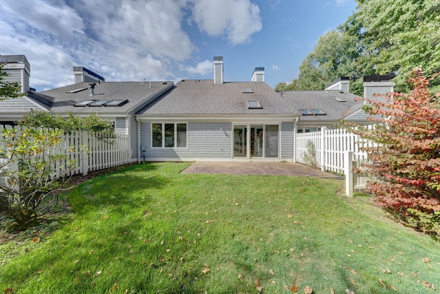 back of house featuring a patio and a yard