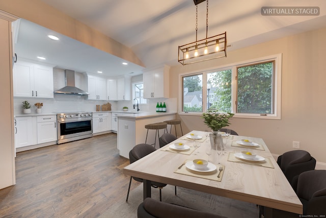 dining space featuring hardwood / wood-style flooring and sink